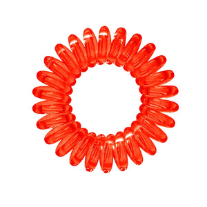 A red coloured plastic spiral circular hair bobble on a white background called a spirabobble.