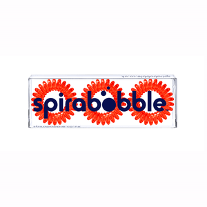 A flat transparent box of 3 red coloured hair accessories called spirabobbles
