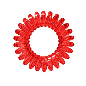A ruby red coloured plastic spiral circular hair bobble on a white background called a spirabobble.