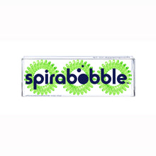 Load image into Gallery viewer, A flat transparent box of 3 spring green coloured hair accessories called spirabobbles.
