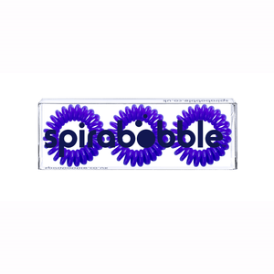 A flat transparent box of 3 purple coloured hair accessories called spirabobbles