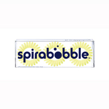 Load image into Gallery viewer, A flat transparent box of 3 pale yellow lemon pie coloured hair accessories called spirabobbles
