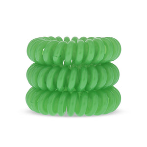A tower of 3 lime green coloured hair bobbles called spirabobbles. A green plastic spiral circular hair tie spira bobble.