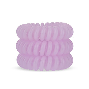 A tower of 3 pink coloured hair bobbles called spirabobbles. A plastic spiral circular hair tie spira bobble.