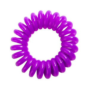 A purple berry coloured plastic spiral circular hair bobble on a white background called a spirabobble.