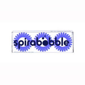 A flat transparent box of 3 purple power violet coloured hair accessories called spirabobbles