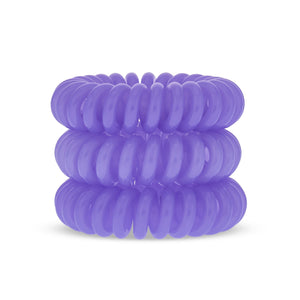 A tower of 3 purple power violet different coloured hair bobbles called spirabobbles. A plastic spiral circular hair tie spira bobble.