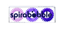 Load image into Gallery viewer, A flat transparent box of 3 purple coloured hair accessories called spirabobbles
