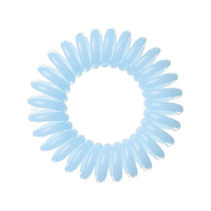 A pale blue solid coloured plastic circular hairband on a white background that looks like an old fashioned curly coiled telephone cable or a coiled spring which has been made into a circular shape