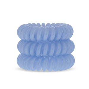 A tower of three (placed on top of each other) pale blue solid coloured plastic spiral circular hair bobbles on a white background that looks like an old fashioned curly coiled telephone cable or a coiled spring which has been made into a circular shape