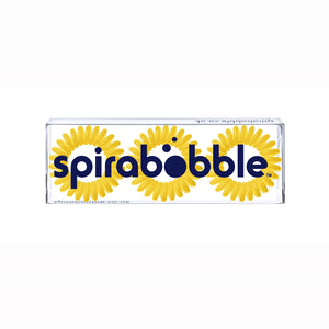 A flat transparent box of 3 sunflower yellow coloured hair accessories called spirabobbles