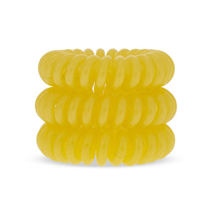 A tower of 3 sunflower yellow coloured hair bobbles called spirabobbles. A plastic spiral circular hair tie spira bobble.