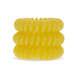A tower of 3 sunflower yellow coloured hair bobbles called spirabobbles. A plastic spiral circular hair tie spira bobble.