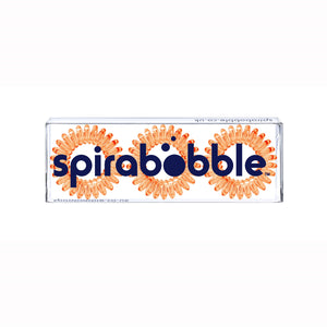 A flat transparent box of 3 Tangerine Orange coloured hair accessories called spirabobbles