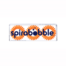 Load image into Gallery viewer, A flat transparent box of 3 Tangerine Orange coloured hair accessories called spirabobbles.
