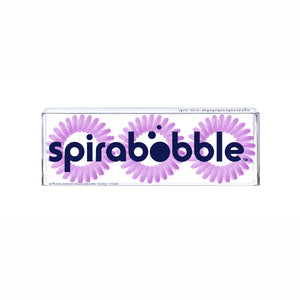 A flat transparent box of 3 Violet Cream coloured hair accessories called spirabobbles.