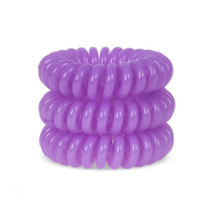 A tower of 3 Violet Cream coloured hair bobbles called spirabobbles. A plastic spiral circular hair tie spira bobble.